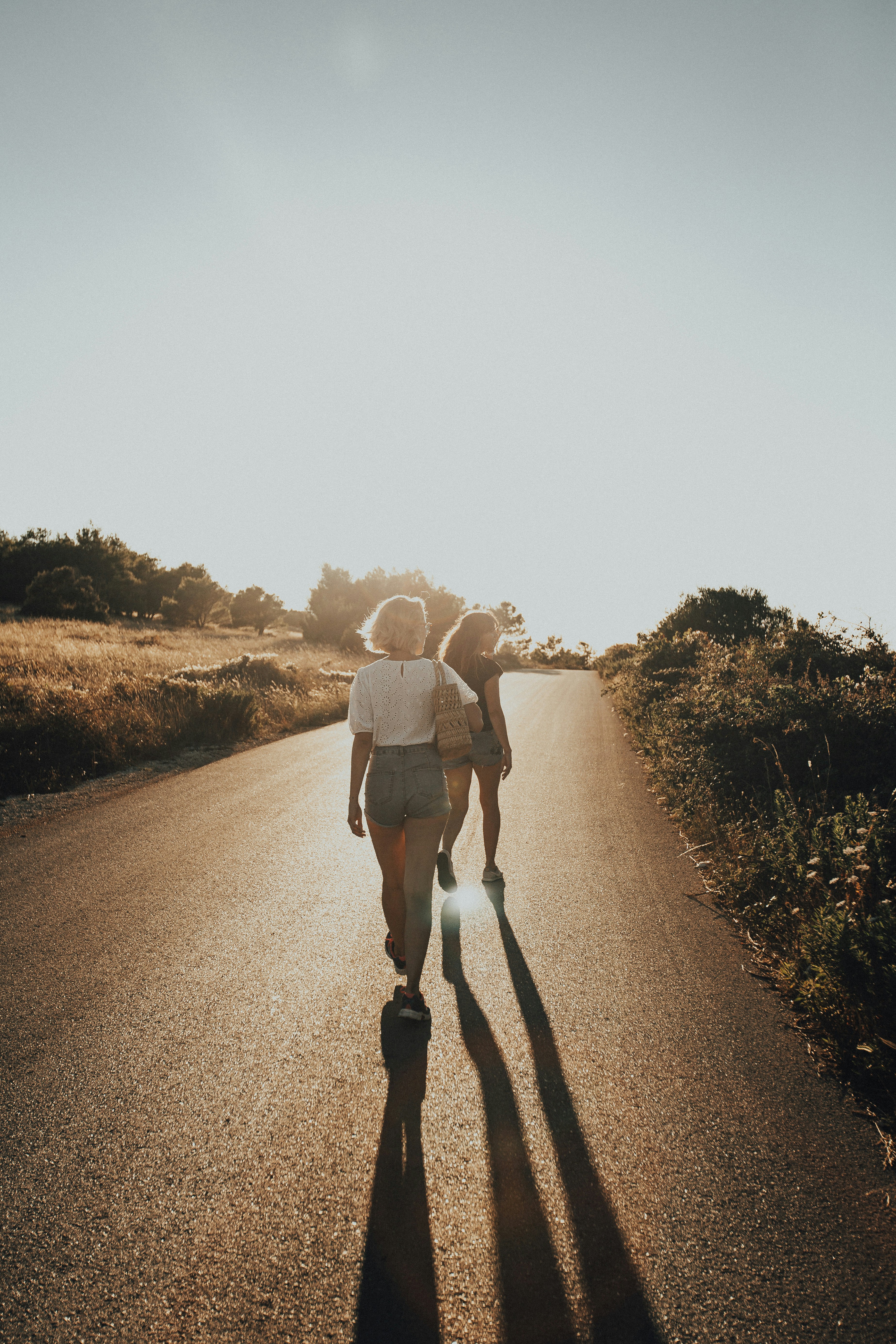 Two people walking at sunset